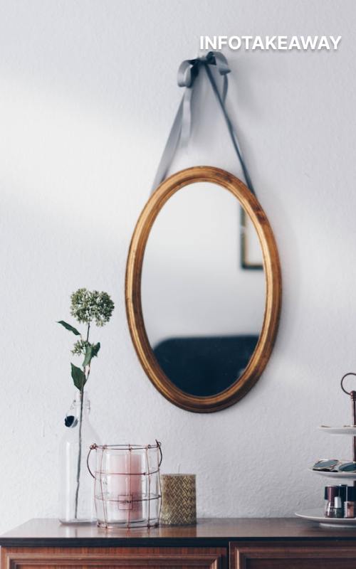 Mirror hanging from ribbon on a wall