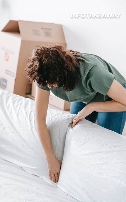 Woman covering the sofa with a sheet