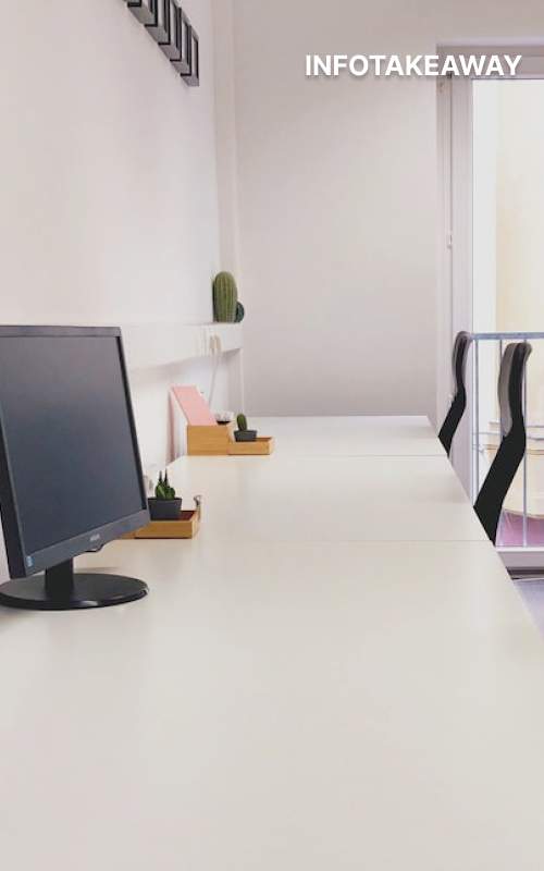 Long table with a screen and chairs