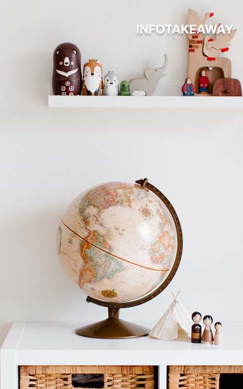 Globe on a desk and a shelf with decorations