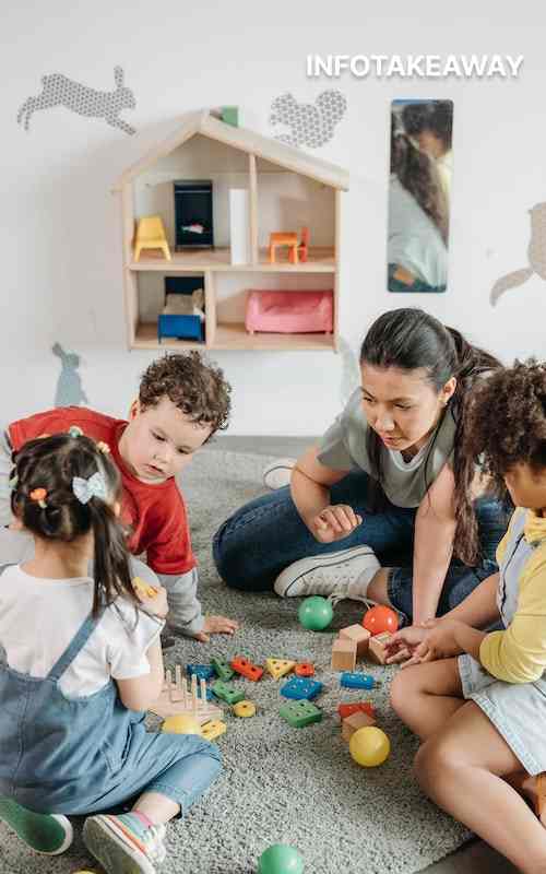 Woman playing with children inside playroom